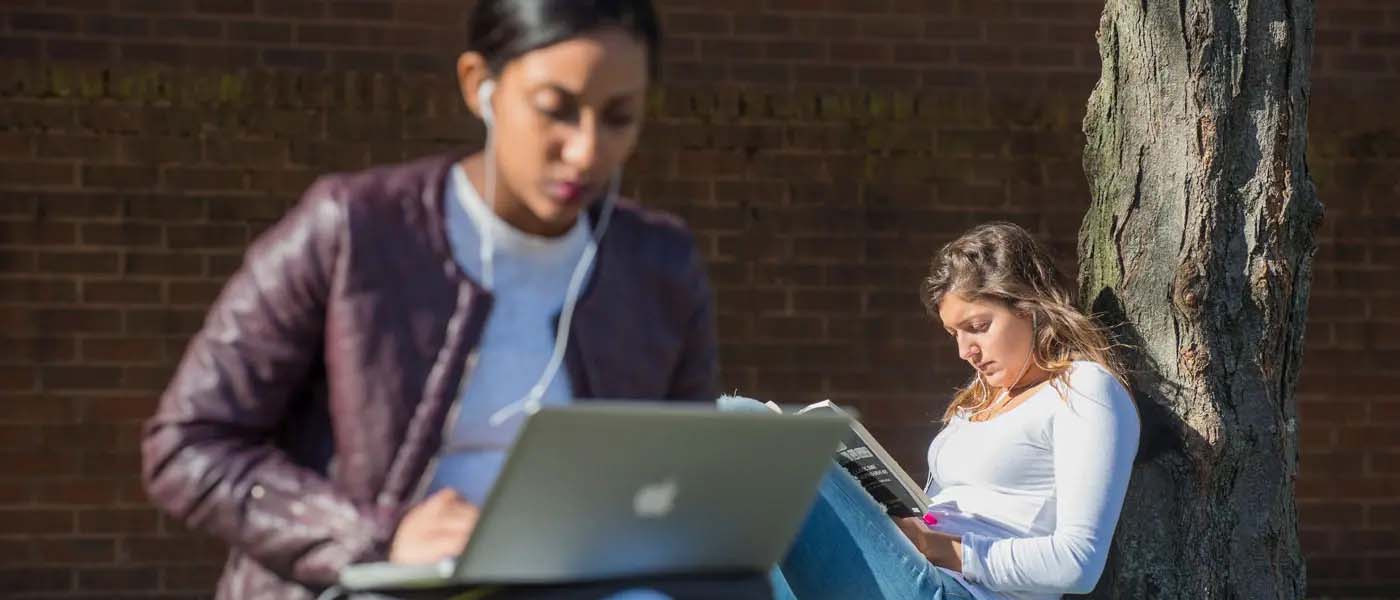 two v.c.u. students studying outside on a sunny day