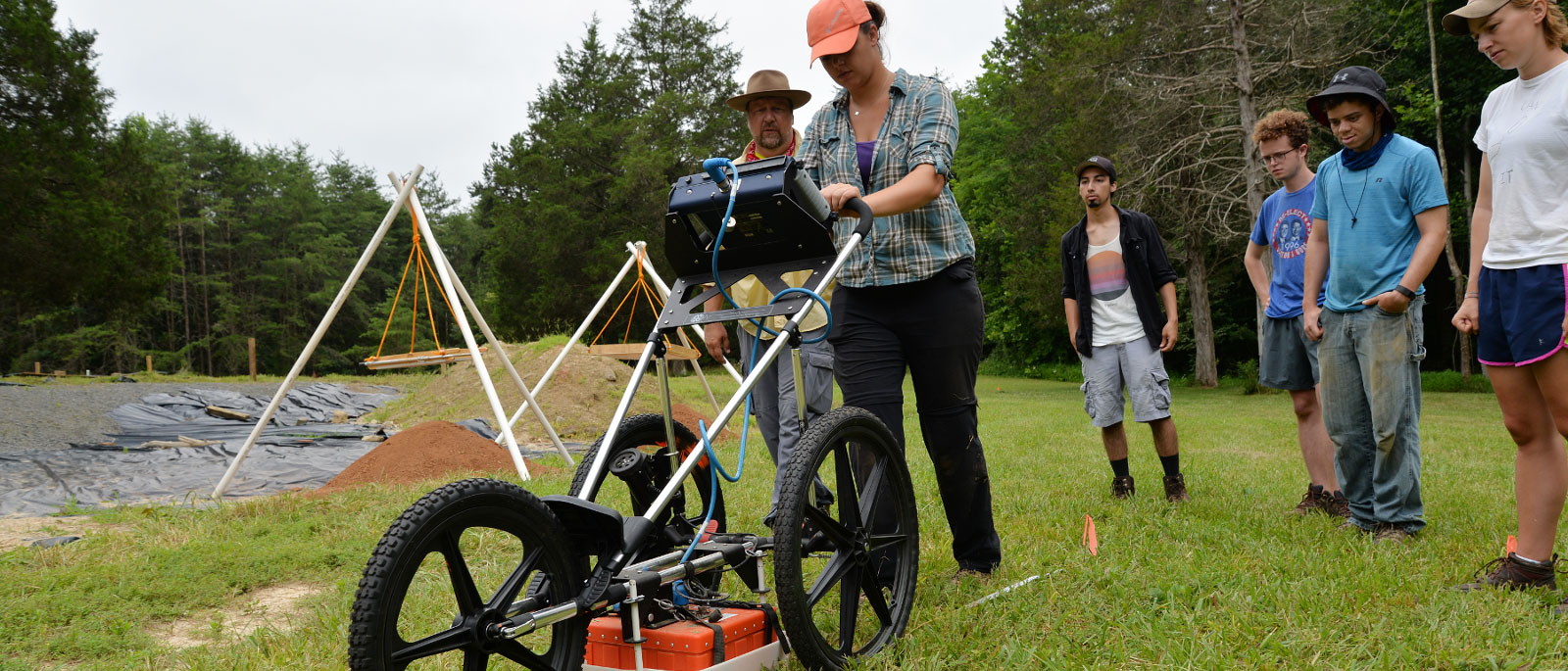 v.c.u. student jesse adkins pushes a ground-penetrating radar device to search for buried anomolies at the Fort Germanna/Enchanted Castle site