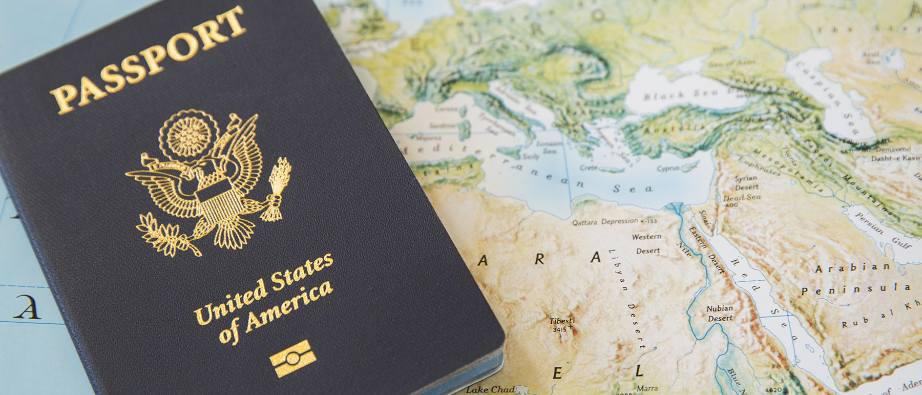 a united states passport lying on top of a world map