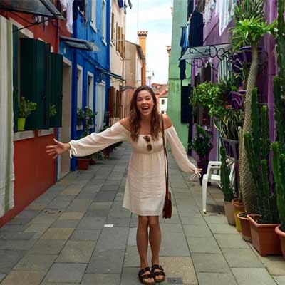 happy v.c.u. student on a colorful street in italy