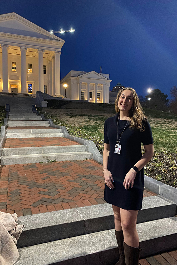 Marina Pugh stands in front of the Virginia Capitol building at night