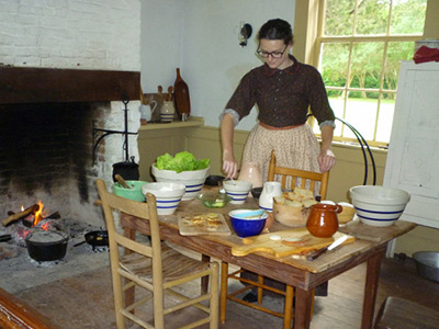 Brenna Geraghty standing behind a table of ingredients